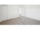 Bedroom features neutral walls and carpet, closet and doorway; blank slate for personal touch at 3550 Moscato Dr, Brooksville, FL 34602
