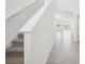 Bright hallway leads to a spacious living area with large windows and tiled floors at 3550 Moscato Dr, Brooksville, FL 34602