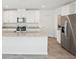 Bright kitchen with granite countertops, stainless steel appliances, and white cabinets offer style and functionality at 3550 Moscato Dr, Brooksville, FL 34602