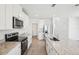 Well-lit kitchen featuring granite countertops, stainless steel appliances, and white cabinetry at 3550 Moscato Dr, Brooksville, FL 34602