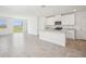 Open-concept kitchen and living area with granite countertops, stainless steel appliances, and large sliding glass doors at 3550 Moscato Dr, Brooksville, FL 34602