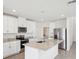 Modern kitchen features granite counters, stainless appliances, a kitchen island, and ample cabinet space at 3550 Moscato Dr, Brooksville, FL 34602