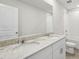 Bathroom featuring double sink vanity, large mirror, and shower with white tile surround at 3921 Radiant Mountain Dr, Plant City, FL 33565
