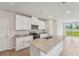 Modern kitchen with stainless steel appliances, granite countertops, and white cabinets at 3921 Radiant Mountain Dr, Plant City, FL 33565