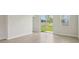 Bright living room with sliding glass doors leading to the backyard and wood-look tile flooring at 3921 Radiant Mountain Dr, Plant City, FL 33565