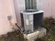 Side view of outdoor air conditioner unit on concrete slabs, with a window at 365 145Th E Ave, Madeira Beach, FL 33708