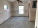 Bright bedroom featuring two windows and a ceiling fan at 365 145Th E Ave, Madeira Beach, FL 33708