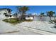 Charming single-story home featuring an ample driveway with palm trees at 365 145Th E Ave, Madeira Beach, FL 33708