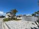 Charming single-story home featuring an ample driveway with palm trees at 365 145Th E Ave, Madeira Beach, FL 33708
