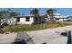 Quaint single-Gathering home with a neutral color palette, complemented by a tidy front yard at 365 145Th E Ave, Madeira Beach, FL 33708