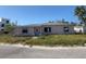 Charming single-story home featuring a classic design with a well-manicured lawn at 365 145Th E Ave, Madeira Beach, FL 33708