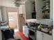 Damaged kitchen featuring white cabinets, appliances, and a ceiling fan at 365 145Th E Ave, Madeira Beach, FL 33708