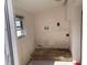 Damaged laundry room with window, utility sink hook-ups and overhead storage cabinet at 365 145Th E Ave, Madeira Beach, FL 33708