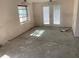 Bare room featuring a window, french doors, damaged walls, and ceiling fan at 365 145Th E Ave, Madeira Beach, FL 33708