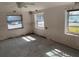 Bare room with three windows, damaged walls, and a ceiling fan at 365 145Th E Ave, Madeira Beach, FL 33708