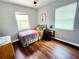Bedroom featuring hardwood floors, ample natural light, and cozy decor at 420 61St S Ave, St Petersburg, FL 33705