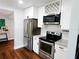 Modern kitchen equipped with stainless steel appliances, sleek white cabinets, and stylish fixtures, offering a blend of style and convenience at 420 61St S Ave, St Petersburg, FL 33705