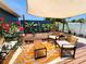 Inviting patio with seating area, colorful rug, wooden table, shade covering and lush landscaping at 420 61St S Ave, St Petersburg, FL 33705