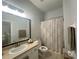 Bathroom with shower featuring vanity with a neutral countertop, and linen storage at 7544 Red Mill Cir, New Port Richey, FL 34653