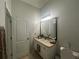 Bright bathroom featuring a vanity, white cabinets, and a neutral countertop at 7544 Red Mill Cir, New Port Richey, FL 34653