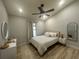 This bright bedroom features a ceiling fan, neutral walls, one window, and wood-look floors at 7544 Red Mill Cir, New Port Richey, FL 34653
