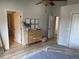 Bedroom featuring wood-look floors, a dresser with decor, and entry ways to other parts of the house at 7544 Red Mill Cir, New Port Richey, FL 34653