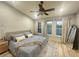 This bright bedroom features a ceiling fan, neutral walls, three windows, and a decorative rug at 7544 Red Mill Cir, New Port Richey, FL 34653