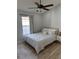 This bright bedroom features a ceiling fan, neutral walls, one window, and wood-look floors at 7544 Red Mill Cir, New Port Richey, FL 34653