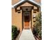Inviting entryway features a brown door with wreath and well-maintained landscaping at 7544 Red Mill Cir, New Port Richey, FL 34653