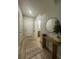 Inviting hallway with wood-look floors, leading to a bathroom and bedrooms at 7544 Red Mill Cir, New Port Richey, FL 34653