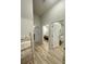 Bright hallway with neutral walls, wood-look floors, and access to the rooms at 7544 Red Mill Cir, New Port Richey, FL 34653