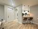 View of kitchen with breakfast bar and modern pendant lighting from entryway at 7544 Red Mill Cir, New Port Richey, FL 34653