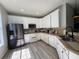 Bright kitchen with stainless steel appliances, and white cabinets at 7544 Red Mill Cir, New Port Richey, FL 34653