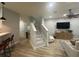 Open-concept living room with staircase, wood floors, and modern furnishings at 7544 Red Mill Cir, New Port Richey, FL 34653