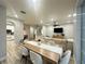 Open-concept living space with dining area, staircase, and modern furnishings at 7544 Red Mill Cir, New Port Richey, FL 34653