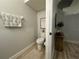 Cozy powder room featuring a stylish towel, artwork, and modern fixtures at 7544 Red Mill Cir, New Port Richey, FL 34653