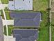 A view of a neighborhood with manicured lawns, showcasing roof, landscaping, and proximity of homes at 10516 Tranquil Meadow Loop, Riverview, FL 33569