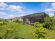 Lush backyard featuring a screened-in lanai and verdant landscaping at 10516 Tranquil Meadow Loop, Riverview, FL 33569