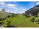 The backyard is lush and green with a screen-enclosed patio in the background at 10516 Tranquil Meadow Loop, Riverview, FL 33569