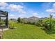 The lawn has beautiful green grass and landscaping and a view of other homes nearby at 10516 Tranquil Meadow Loop, Riverview, FL 33569