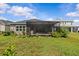 Expansive backyard features a screened lanai that provides shade for outdoor entertaining and relaxation at 10516 Tranquil Meadow Loop, Riverview, FL 33569