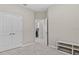 This bedroom features neutral walls, carpet flooring, closet, and access to the laundry room at 10516 Tranquil Meadow Loop, Riverview, FL 33569