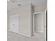 Bedroom with white doors, neutral carpet and walls, and a view into an ensuite bathroom at 10516 Tranquil Meadow Loop, Riverview, FL 33569