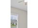 Bedroom with a ceiling fan and natural light from a large window with view of neighboring houses at 10516 Tranquil Meadow Loop, Riverview, FL 33569
