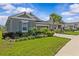 A well-kept single-story home with an attached two-car garage and lush green landscaping at 10516 Tranquil Meadow Loop, Riverview, FL 33569