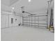 This spacious garage features epoxy flooring, storage racks, and an automatic garage door opener at 10516 Tranquil Meadow Loop, Riverview, FL 33569