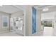 Elegant hallway with accent wall, built-in shelves, and a clear view to the open living area at 10516 Tranquil Meadow Loop, Riverview, FL 33569