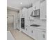 White cabinets with stainless steel appliances and modern oven features enhance this kitchen's appeal at 10516 Tranquil Meadow Loop, Riverview, FL 33569