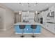 Spacious kitchen island with white countertop, seating, and stainless steel sink; white cabinetry throughout at 10516 Tranquil Meadow Loop, Riverview, FL 33569
