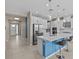Bright kitchen features a central island with seating, stainless steel appliances, and modern pendant lighting at 10516 Tranquil Meadow Loop, Riverview, FL 33569